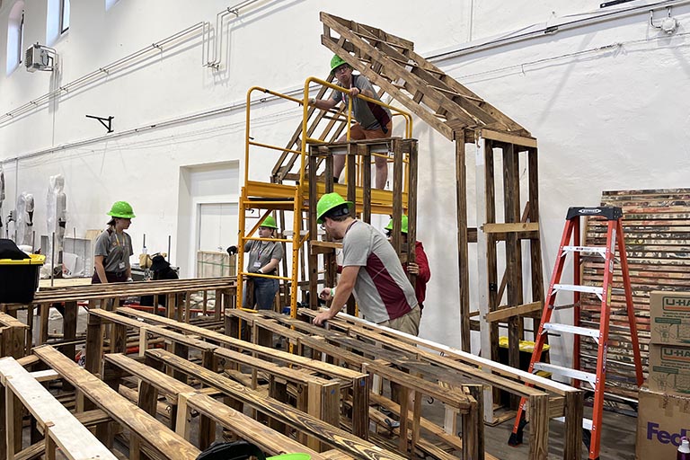 The cabin-like frame is built for the "Our House" installation.