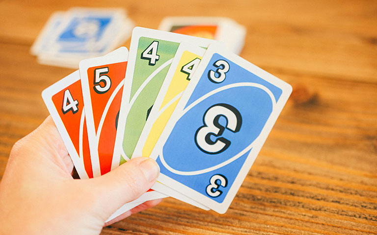 A person holding a hand of Uno cards