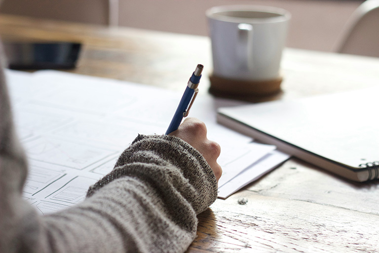 A person writing in a notebook