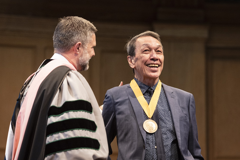 Eduardo Sicangco being honored with the UNC System Board of Governors Excellence in Teaching Award by Chancellor Brian Cole at the 2023 UNCSA University Commencement ceremony. / Photo: Allison Lee Isley