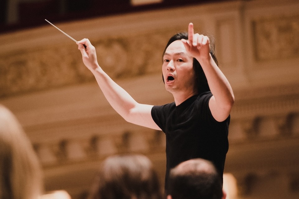 Christopher Tin conducting at Carnegie Hall; Photo: Dan Wright