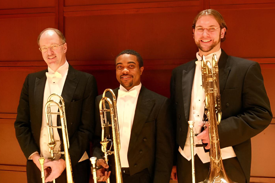 Seville Jenkins playing his first cycle as substitute second trombone with the North Carolina Symphony next his UNCSA professor, John Ilika, principal trombone. / Contributed photo