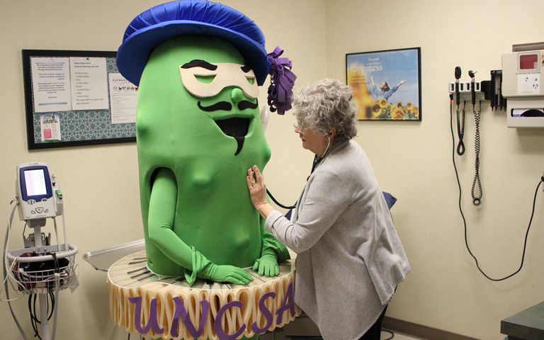 Medical person examine the Fighting Pickle