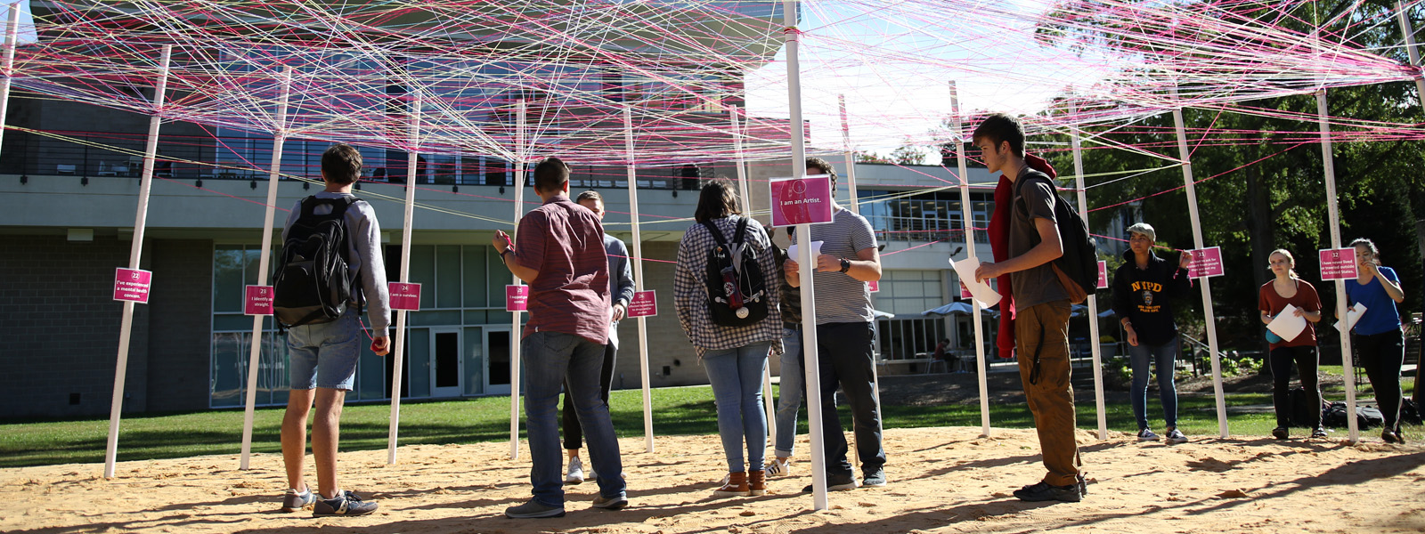 Students finding connections by weaving strings