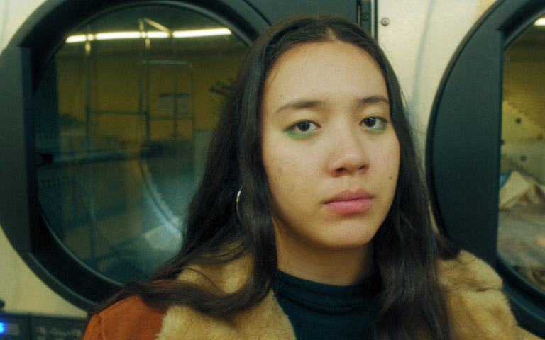 Female sitting on a train looking.